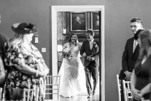 wedding photography at hodsock priory. Bride and father of the bride walking down the aisle.