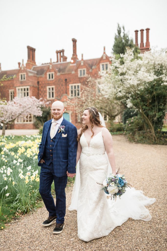 wedding photography at hodsock priory. The bride and groom walking together.